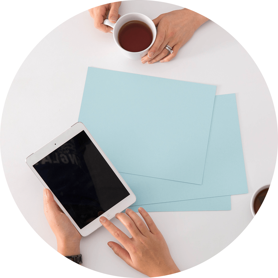 two people enjoying coffee and using an ipad